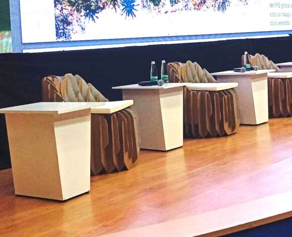 a group of tables with chairs and a screen
