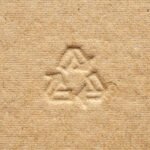 a recycle symbol carved in a cardboard