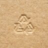 a recycle symbol carved in a cardboard